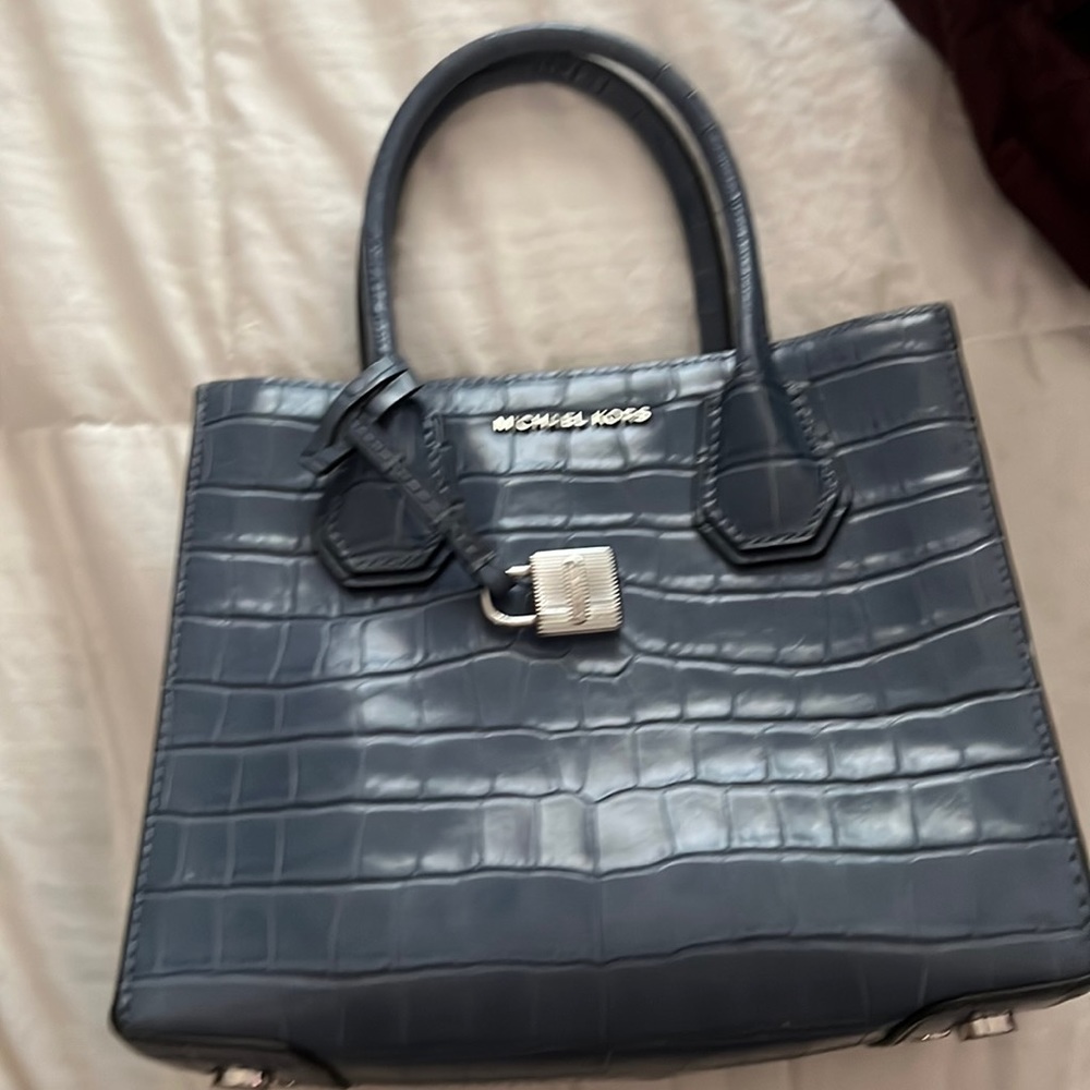 Michael Kors small blue purse with attachable strap. Never used.